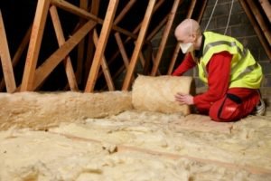Man laying insulation in a loft in Bristol